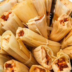 several tamales filled with meat and seasoning on a plate