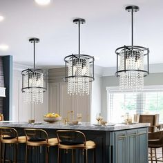 a kitchen with an island, bar stools and chandelier