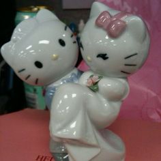 a hello kitty figurine sitting on top of a pink box