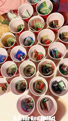 several cups filled with money sitting on top of a table