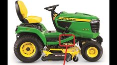 a green and yellow lawn tractor parked on top of a white background with the words john deere written below it