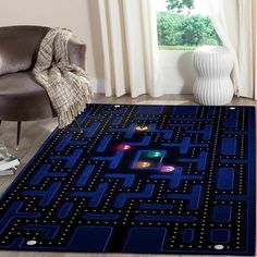 a blue rug with an image of a pacman game on it in front of a chair