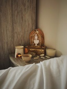 a wooden table topped with bowls and candles