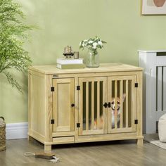 a wooden cabinet with two dogs in it next to a potted plant on the floor