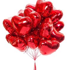 a bunch of red heart shaped balloons