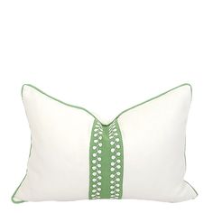 a white pillow with green trim on it