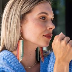 Fabulous free-flowing fringe is just what your jewelry box needs! Part of our signature seed bead collection, these handmade statement earrings are lightweight enough for all-day wear but bold enough to make a big statement. Warning: Main character energy will arise. Style tip: Looking to radiate positivity? These are the earrings for you. Teal, mint, blush, orange, pink + purple beads create the most beautiful ombre rainbow effect that'll take you from conference calls to happy hour and everywh Block Print Scarf, Main Character Energy, Bead Collection, Beaded Chandelier Earrings, Beaded Fringe Earrings, Beaded Cross, Colorful Jewelry, Triangle Earrings, Beaded Fringe