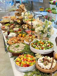 a buffet table filled with lots of different types of desserts and pastries on it