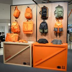 there are many bags and backpacks on display