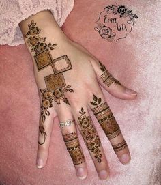 a woman's hand with henna tattoos on it