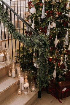 a decorated christmas tree sitting on top of a set of stairs