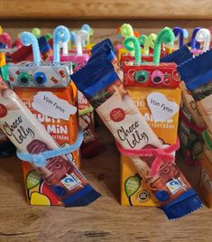 some candy bars are lined up on a table with toothbrushes sticking out of them