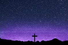 a cross on top of a hill under a purple sky filled with stars and clouds