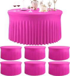 the table is covered with pink pleated cloths and wine glasses are on it