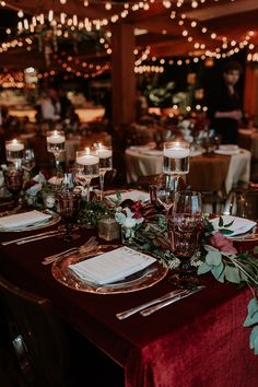 the table is set with place settings and candles