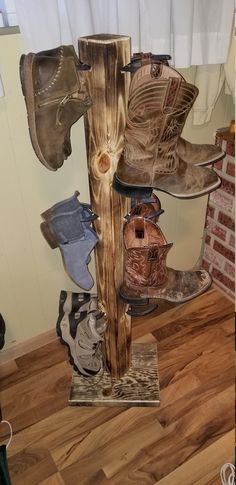 there are many pairs of shoes that are on the stand in the room with wood flooring