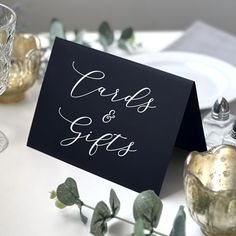 a table setting with place cards and silverware