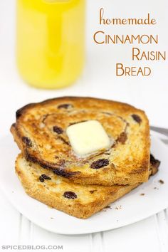 homemade cinnamon raisin bread on a white plate next to a glass of orange juice