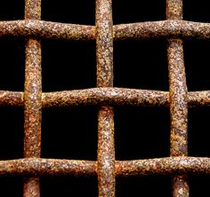 a close up view of an old rusted metal fence