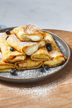 pancakes with blueberries and powdered sugar on a plate