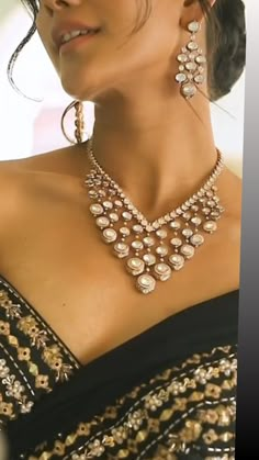 This Gorgeous Sabyasachi inspired Gold  Necklace with matching earrings. Comprises of Fine Oversized Uncut Kundan polki stones with navratan stone This choker is flexible and takes the shape of the neck. Fine quality and craftsmanship. Perfect for desi weddings. Necklace comes in drawstring cord therefore adjustable Earrings length: Approx 2.5 inches Luxury Bollywood Kundan Necklace With Meenakari, Luxury Traditional Necklaces With Sparkling Stones, Luxury Bridal Necklace With Stone Work For Diwali, Luxury Gold Kundan Necklace Cubic Zirconia, Luxury Kundan Chandbali Necklace With Pearl Drop, Luxury Kundan Necklaces For Puja, Luxury Kundan Jewelry With Detachable Pendant, Luxury Gold Kundan Bollywood Necklace, Luxury Kundan Designer Necklace