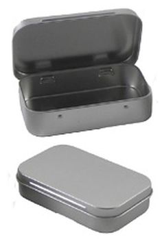 an open tin container sitting on top of a white table next to a silver lid