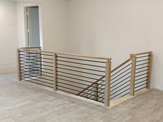 an empty room with wood and metal railings