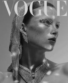 a woman wearing jewelry on the cover of a magazine, with her face covered in jewels