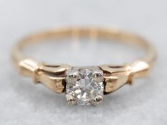 This vintage engagement ring is sweet and feminine, while still being easy to wear every day. The stone is encased in a square, white gold head. This protects the diamond and also allows some light into the bottom to shine up through the stone. Simply adorned yellow gold shoulders provide a wonderful balance to the geometric, Illusion style head!Metal: 14K Yellow and White GoldGem: Diamond .24 Carats, VVS2 in Clarity, H in ColorGem Measurements: 4.0 mm, roundRing Size: 5.75Marks: "14K" Stamped on the inside band Geometric Illusion, Gold Engagement Ring Diamond, Bypass Engagement Ring, Engagement Ring Diamond, Gold Diamond Engagement Rings, Vintage Engagement Ring, Diamond Solitaire Ring, Engagement Ring Diamond Cut, Dream Engagement Rings