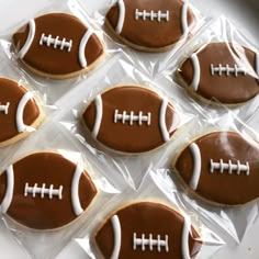 six decorated cookies in the shape of footballs