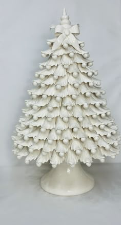 a white ceramic christmas tree sitting on top of a table