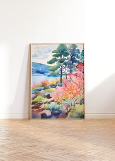 a painting hanging on the wall in an empty room with wood flooring and white walls