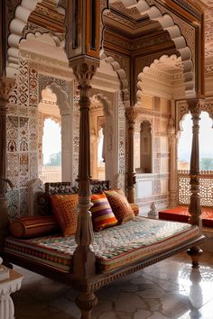 a bed sitting in the middle of a room with lots of furniture on top of it