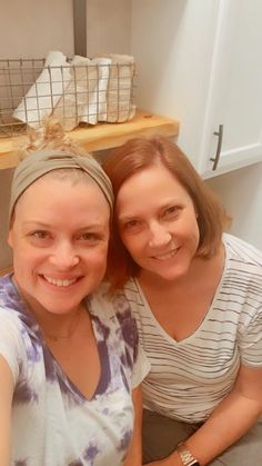 two women sitting next to each other smiling