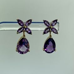 * Designer Mexico 14k Yellow Gold Amethyst Dangle Drop Floral Flower Stud Earrings * Length: 3/4" * Width: 5/16" * (8) Marquise Amethyst Measure Approximately 4.1 Mm X 2.5 Mm Each * (2) Pear Amethyst Measure Approximately 10.0 Mm X 6.8 Mm Each * Weight: 2.7 Tgw * Marked: 14k * Makers Mark * Mexico * Fastening: Earring Backs Not Included * Condition: As Pictured. * G1677 Amethyst Earrings Studs, Flower Stud Earrings, Flower Stud, Amethyst Earrings, Flower Earrings Studs, Flower Studs, Floral Flower, Earring Backs, Floral Flowers