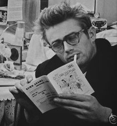 a man with glasses is reading a book