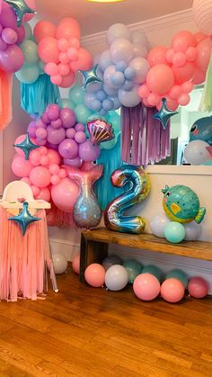 a room filled with lots of balloons and decorations