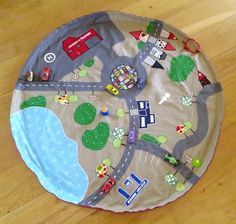 a child's play mat on the floor with cars and trucks painted on it