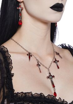 This jewelry set comes with a statement necklace that features multiple cross and dagger charms, a large red gemstone, and matching drop earrings. Vampire Goth Accessories, Crucifix Metal Jewelry, Goth Cross, Vampire Jewelry, Blood Drop, Goth Accessories, Halloween Goth, Vampire Goth, Faith Jewelry