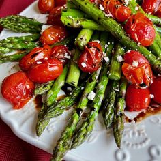 asparagus, cherry tomatoes and toasted bread on a plate