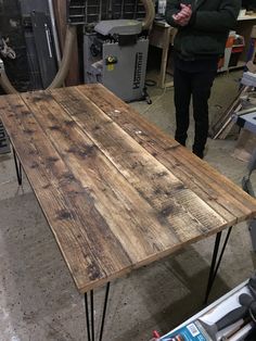 a wooden table with hairpin legs in a shop