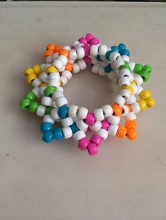 multicolored bracelets sitting on top of a white table next to each other