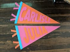 two pieces of paper with the words carlisle and julia on them sitting next to each other