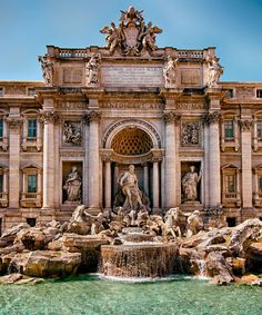 the trellotto fountain in front of an ornate building with statues on it's sides