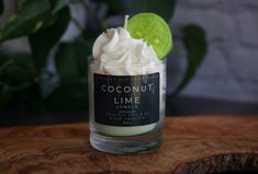 a small glass jar filled with whipped cream and a lime slice on top of it