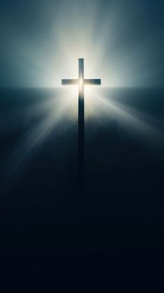 a cross with the sun shining through it