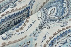 the fabric is blue and white with an intricate pattern