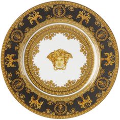 a black and gold plate with a lion head on it