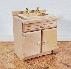 a wooden sink and cabinet on the floor in a room with hard wood parquet