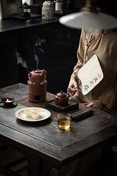 a person sitting at a table with some food on it